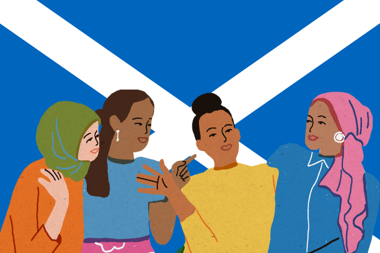 Four women of colour having a conversation in front of a Scottish flag.